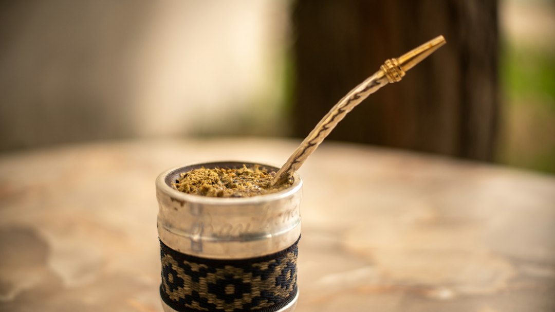 Yerba mate gourd with bombilla on a table outdoors